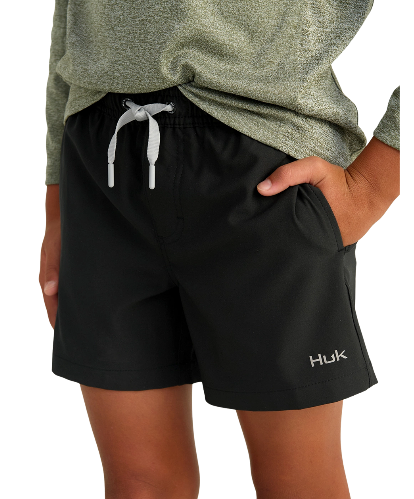 Black shorts with a visible brand logo worn by a person on a white background