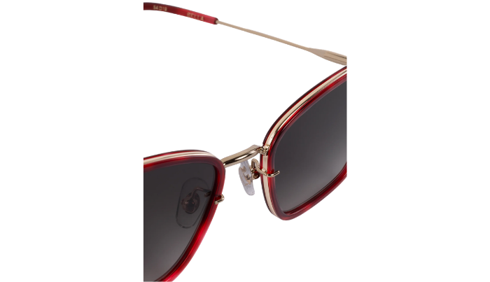 Krewe sunglasses with red frames and dark lenses on a white background