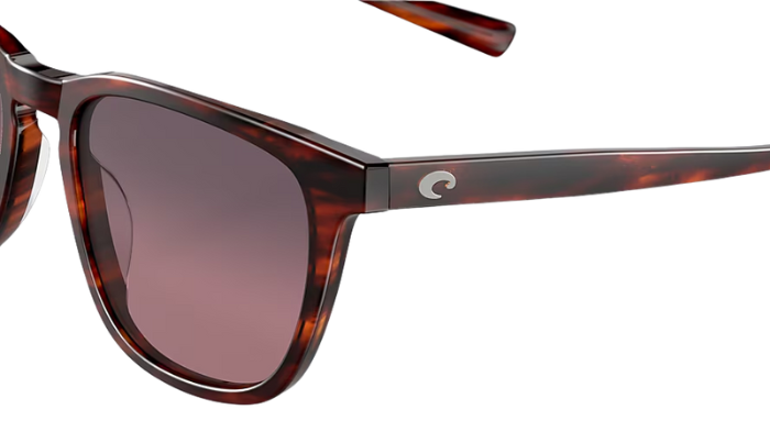 Costa Sunglasses with tortoiseshell frame and rose lenses on a white background
