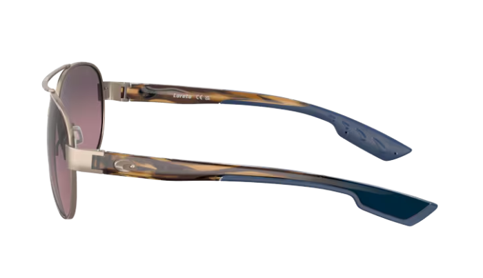 Aviator Costa sunglasses with a gradient pink lens on a white background