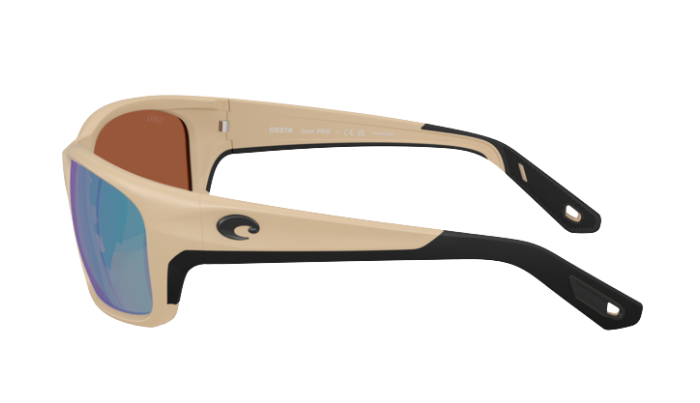 Matte sand Costa sunglasses with green polarized reflective lenses on a white background