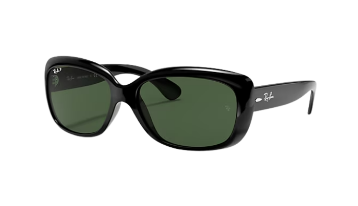 Black sunglasses with green lenses on a white background