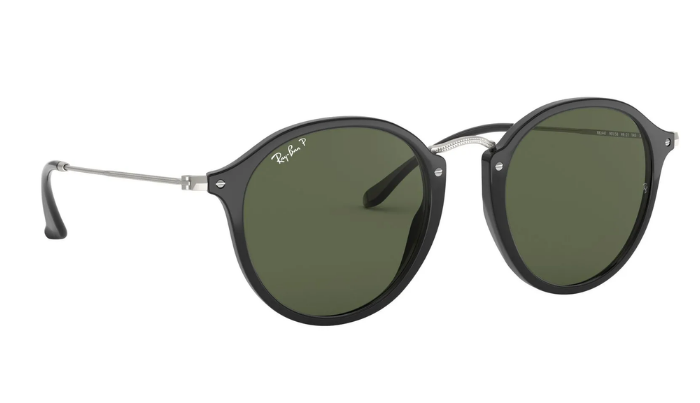 Round Ray-Ban sunglasses with black frames and green polarized lenses on a white background