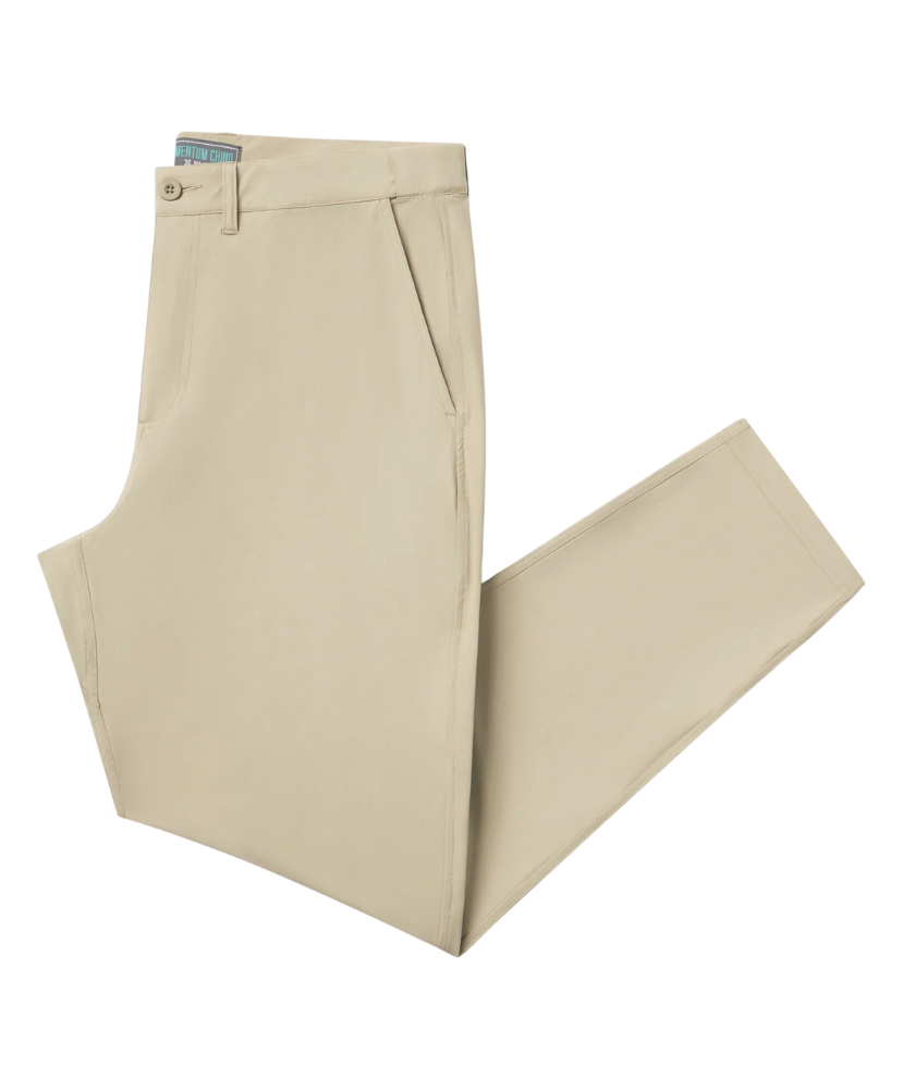 Beige PERFORMANCE pants folded on a white background