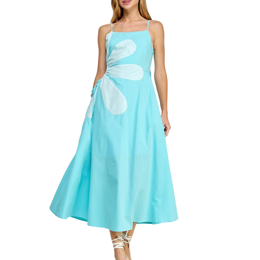 Woman wearing a light blue dress with white floral patterns on a white background