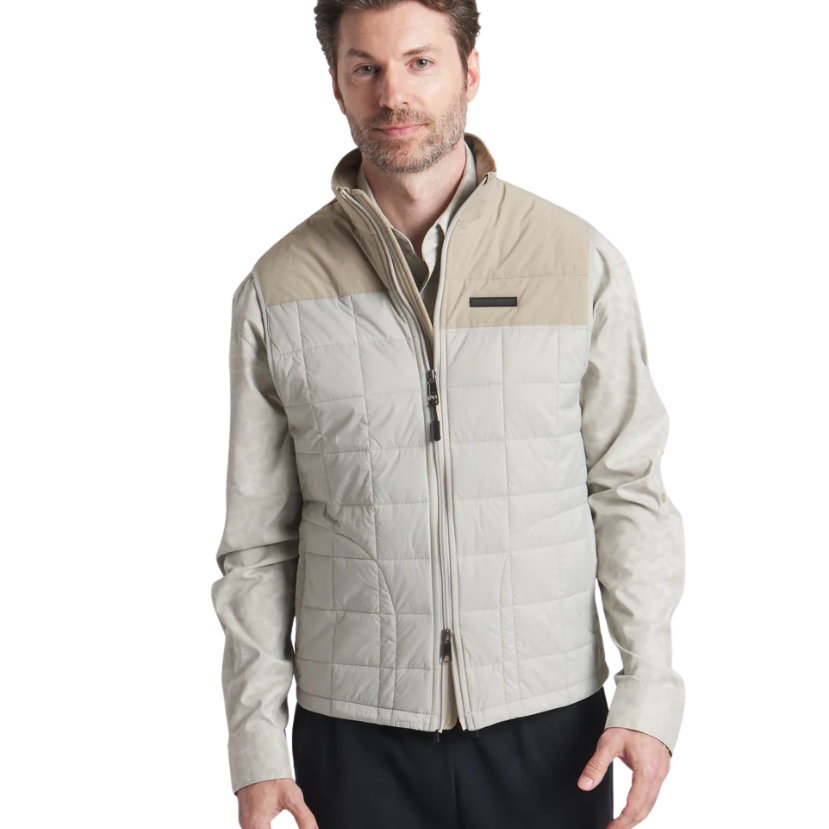 Man wearing a beige quilted jacket on a white background
