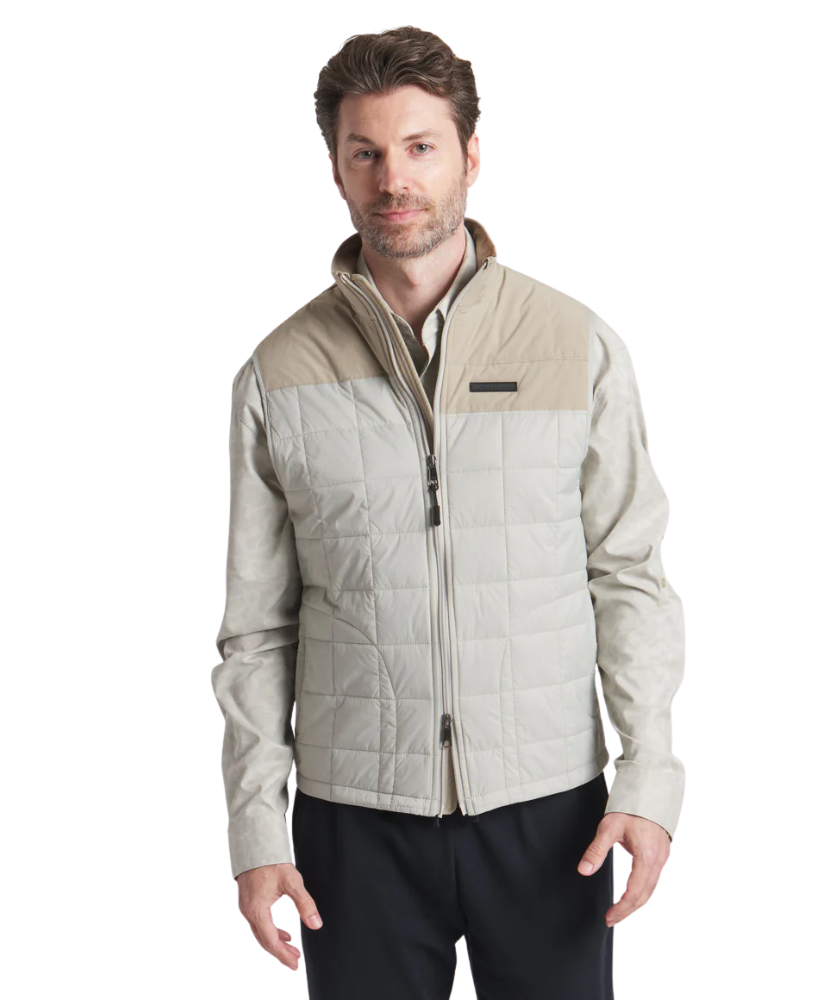 Man wearing a beige quilted jacket on a white background