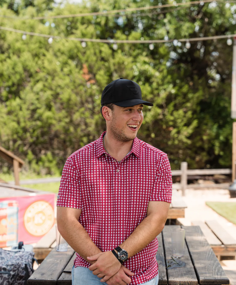 Man wearing red and white polo with Alabama state outline print. Perfect for Game Day.