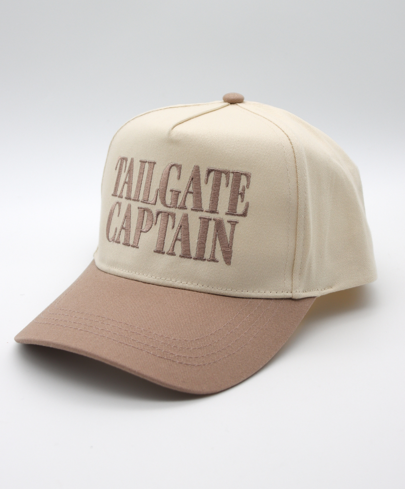 Beige and brown cap with 'Tailgate Captain' text on a light gray background