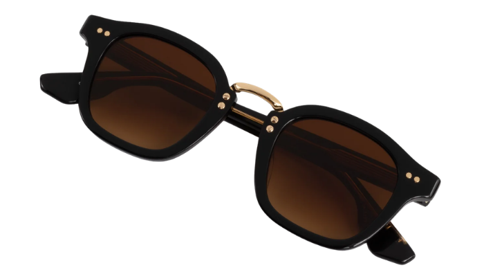 Black Krewe sunglasses with gold accents on a white background