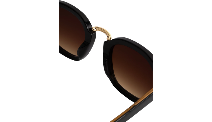 Black Krewe sunglasses with gold accents on a white background