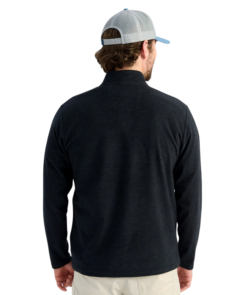 Man wearing a black long-sleeve shirt and a gray cap on a white background