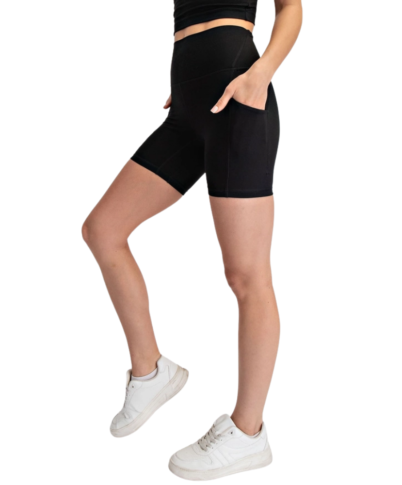 Person wearing black biker shorts on a white background