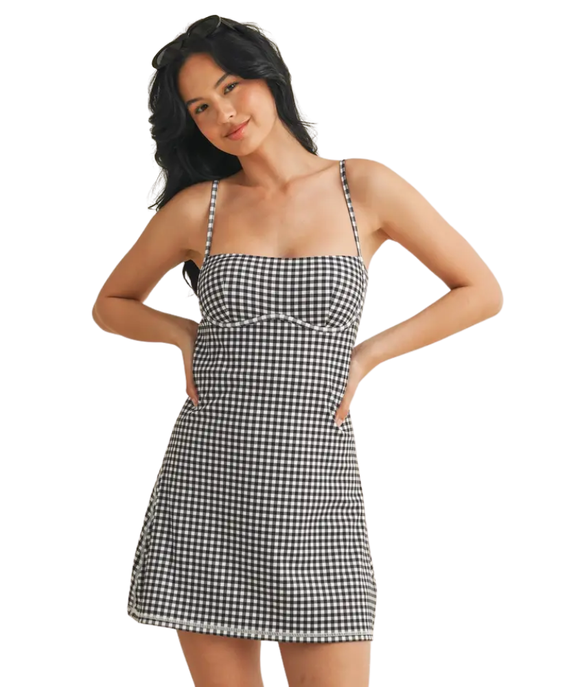 Woman wearing a black and white checkered dress on a white background