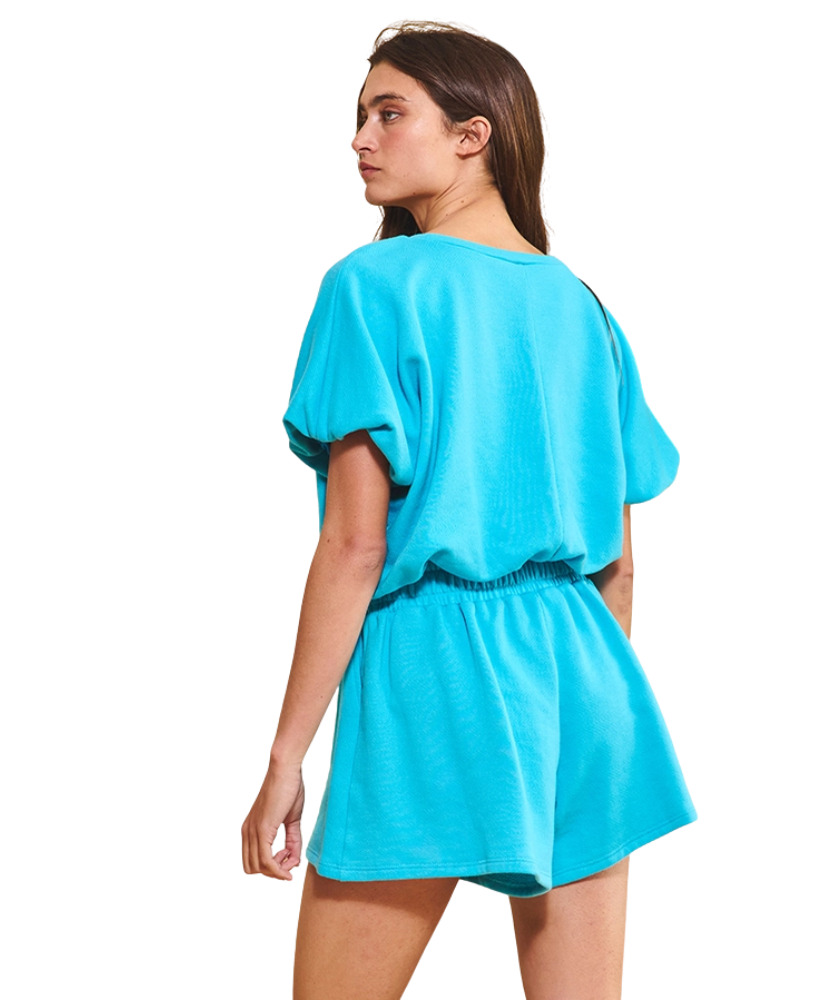 Woman wearing a turquoise dress on a white background