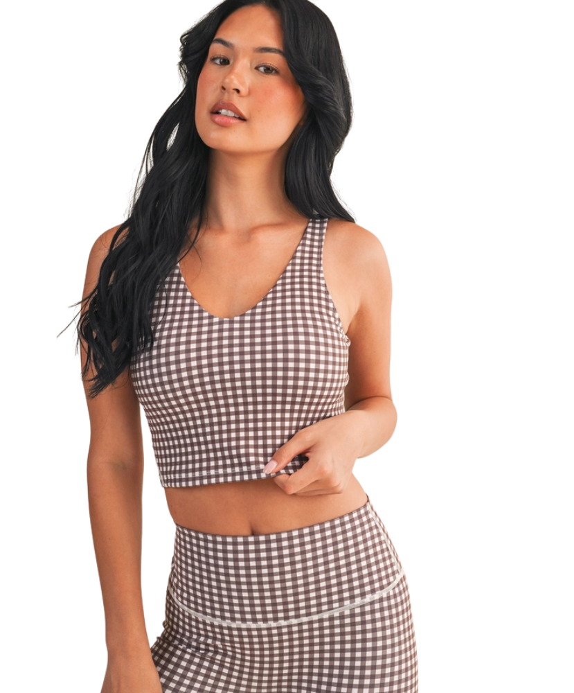 Woman wearing a brown and white GINGHAM checkered tank on a white background