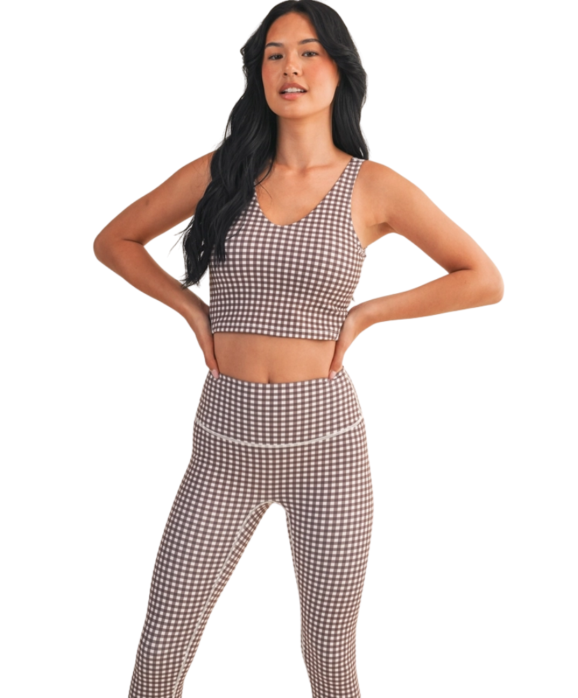 Woman wearing a brown and white GINGHAM checkered tank on a white background