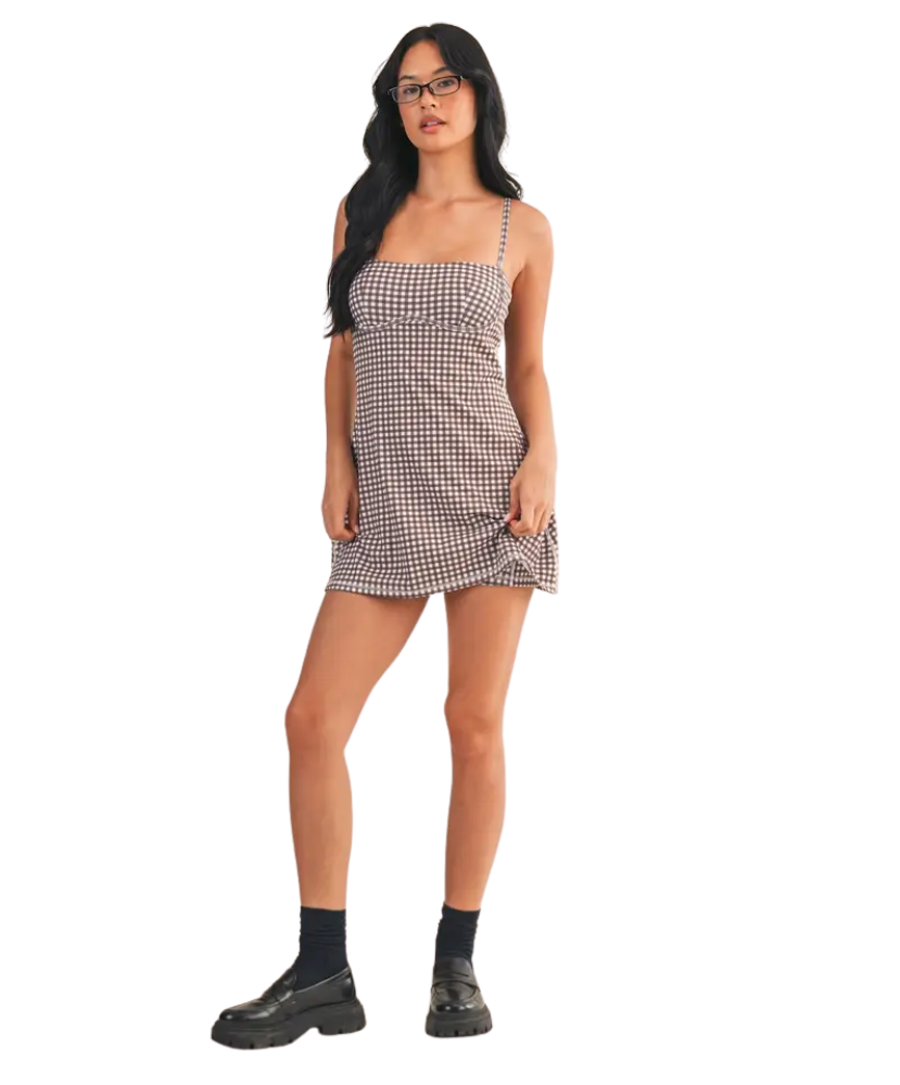 Woman wearing a checkered dress on a white background