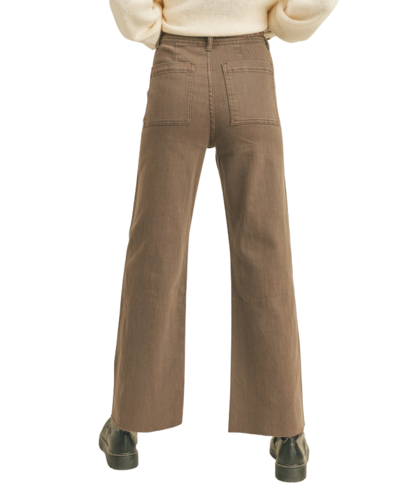 Brown pants worn by a woman on a white background
