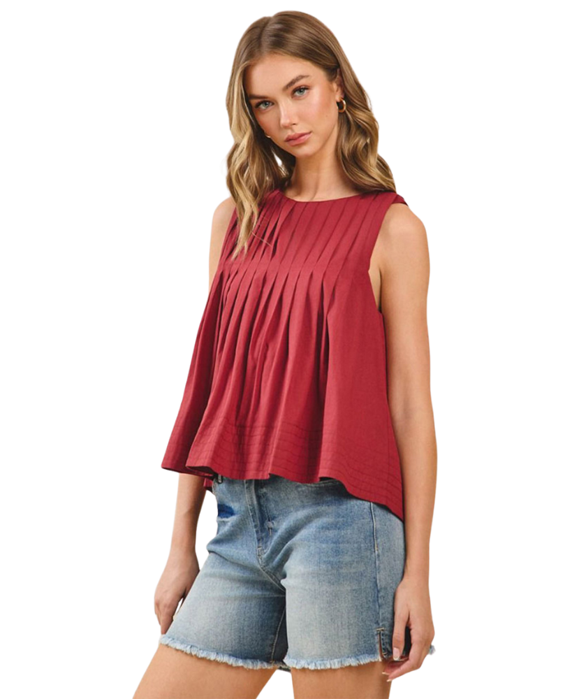 Woman wearing a burgundy sleeveless top and denim shorts on a white background