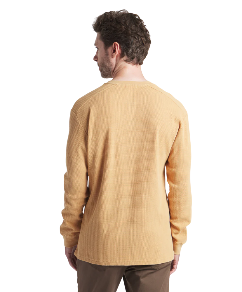 Man wearing a mustard yellow long-sleeve henley shirt on a white background