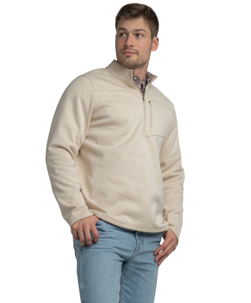 Tan quarter zip pullover with a plaid shirt underneath on a white background