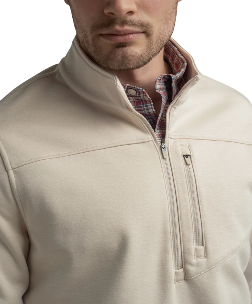 Tan quarter zip pullover with a plaid shirt underneath on a white background