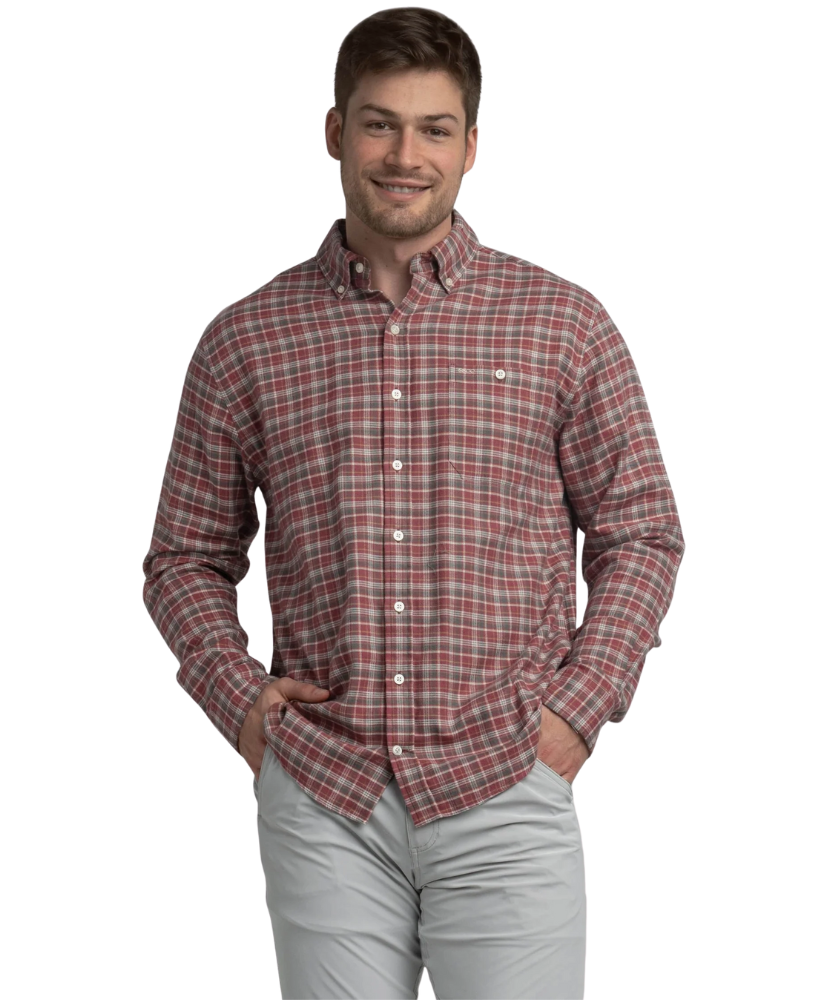 Man wearing a red and brown plaid shirt on a white background