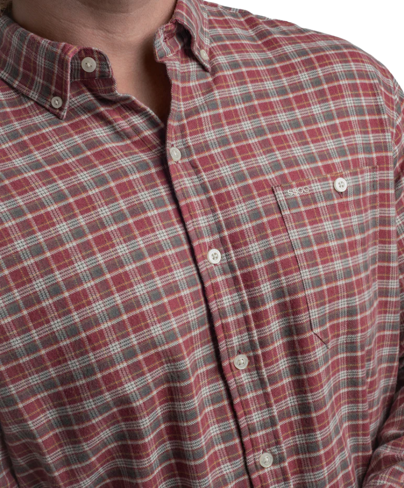 Red and gray plaid shirt with a brand logo on a white background