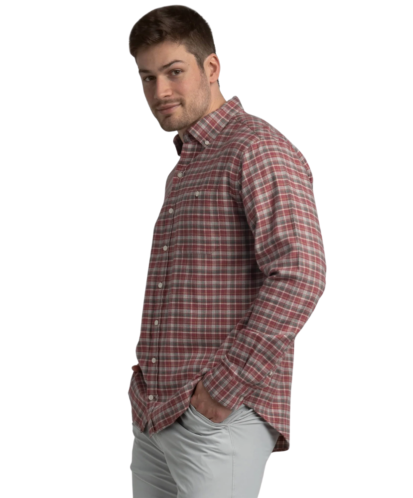 Man wearing a red and gray plaid shirt on a white background