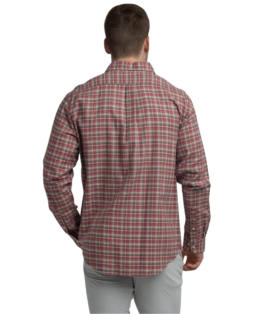 Man wearing a red and gray plaid shirt on a white background