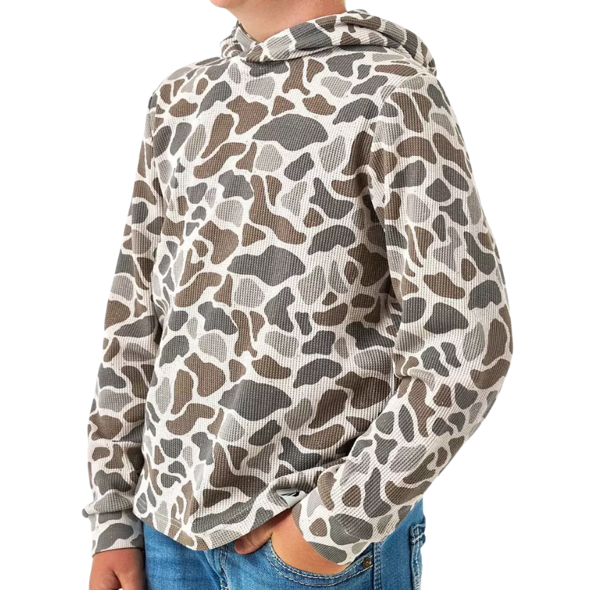A child wearing a long-sleeve hooded top with an allover organic animal-print pattern in beige, brown, and gray, paired with blue jeans against a plain white background.