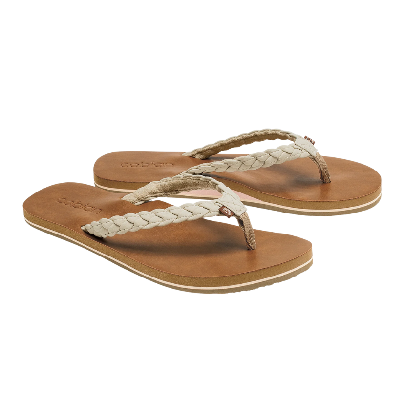 Pair of tan sandals with braided straps on a white background
