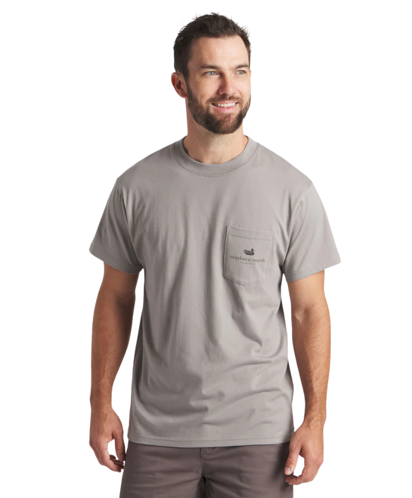 Man wearing a gray t-shirt with a logo on a white background