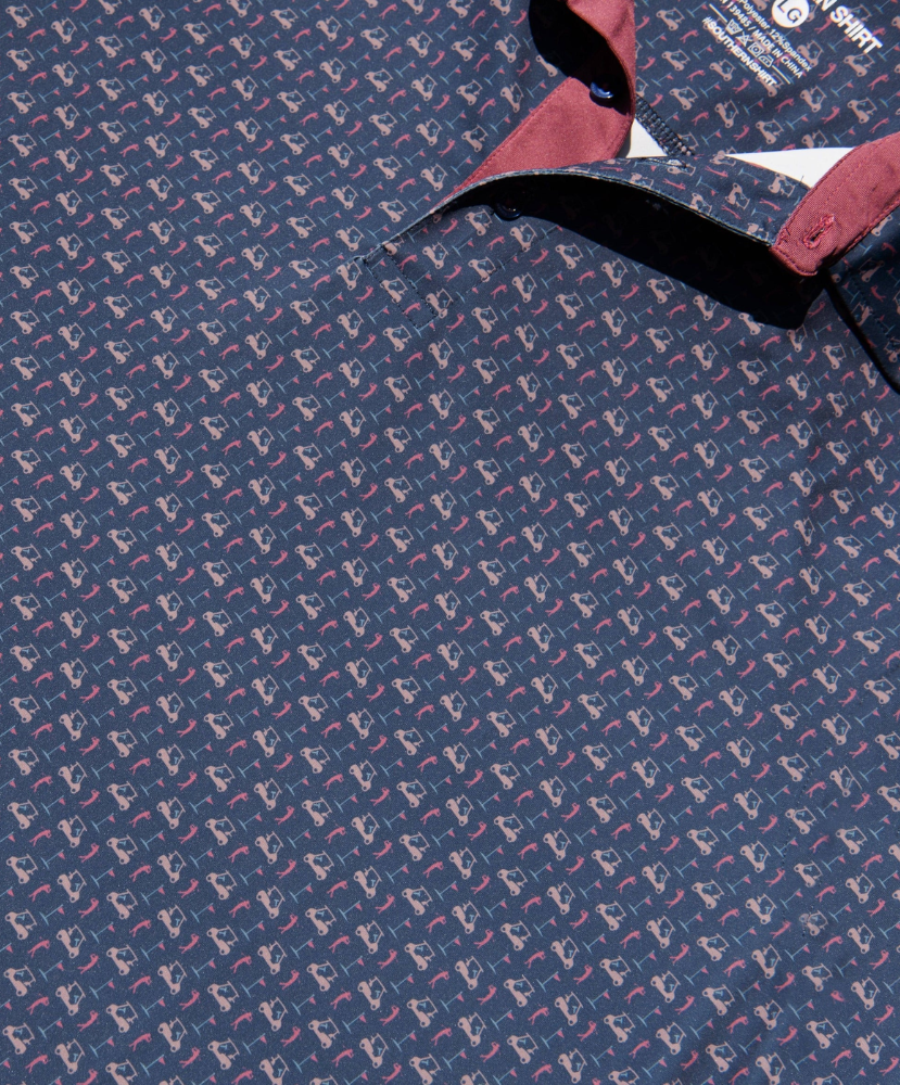 Close-up of a golf cart and palm tree patterned polo shirt with a visible brand label.