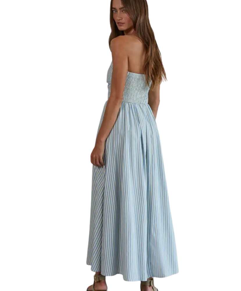 Woman wearing a light blue striped dress on a white background