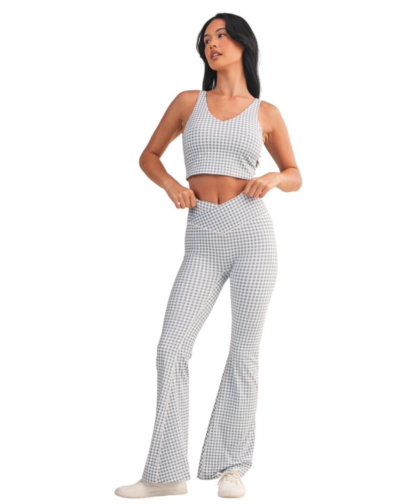 Woman wearing a light blue and white GINGHAM checkered tank on a white background