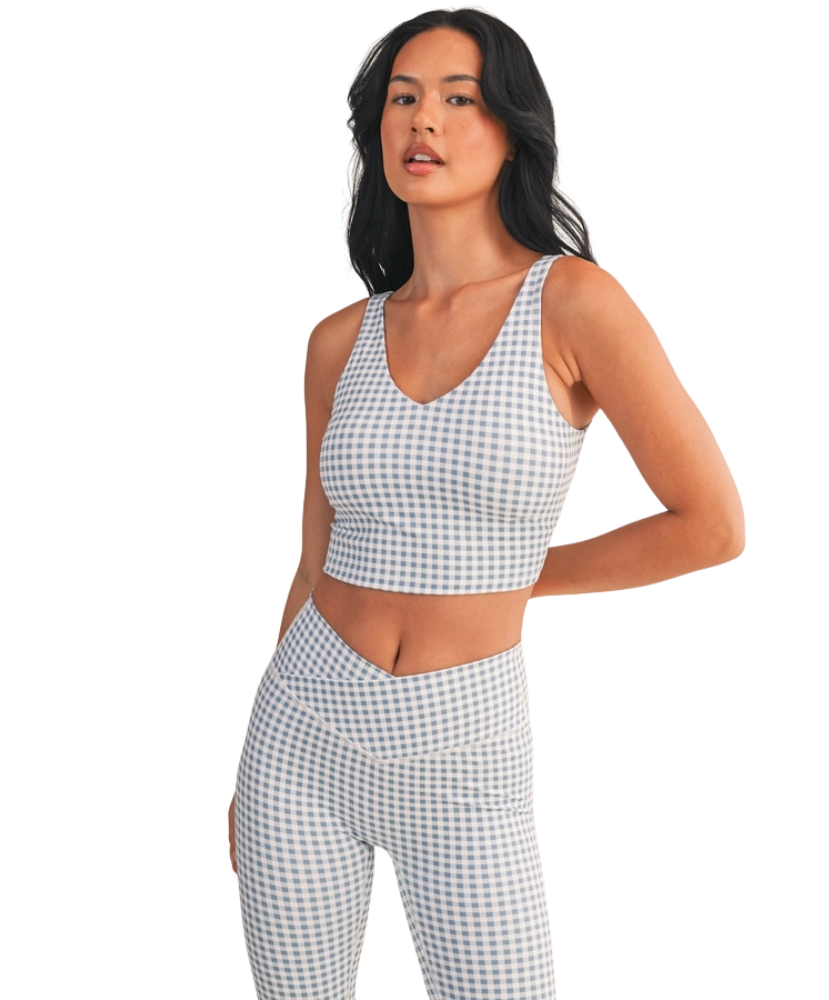 Woman wearing a light blue and white GINGHAM checkered tank on a white background
