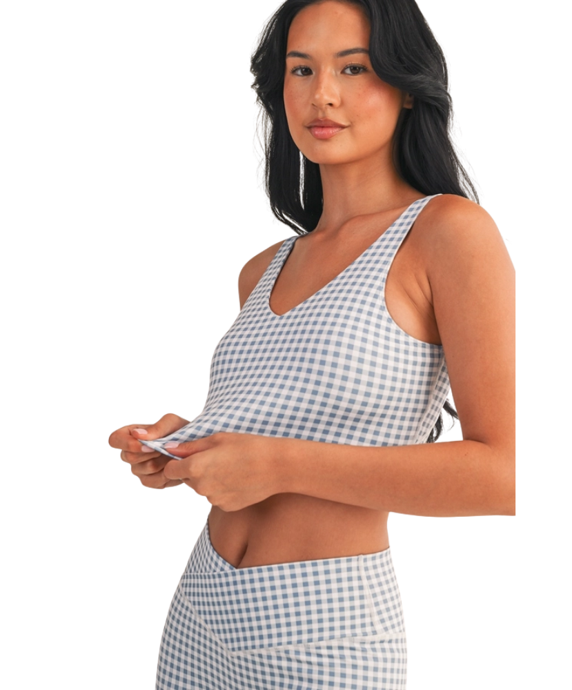 Woman wearing a light blue and white GINGHAM checkered tank on a white background