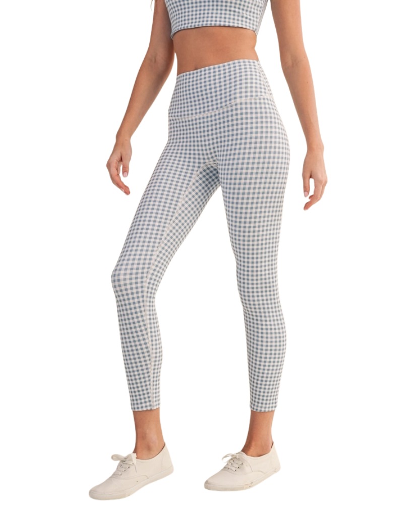 Person wearing blue and white gingham checkered outfit with leggings and a top on a white background