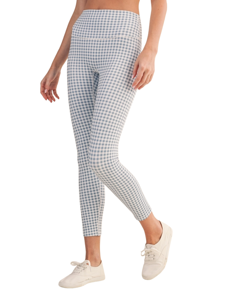 Person wearing blue and white gingham checkered outfit with leggings and a top on a white background
