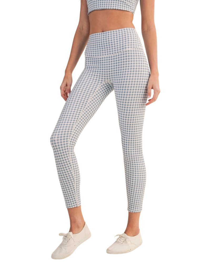 Person wearing blue and white gingham checkered outfit with leggings and a top on a white background