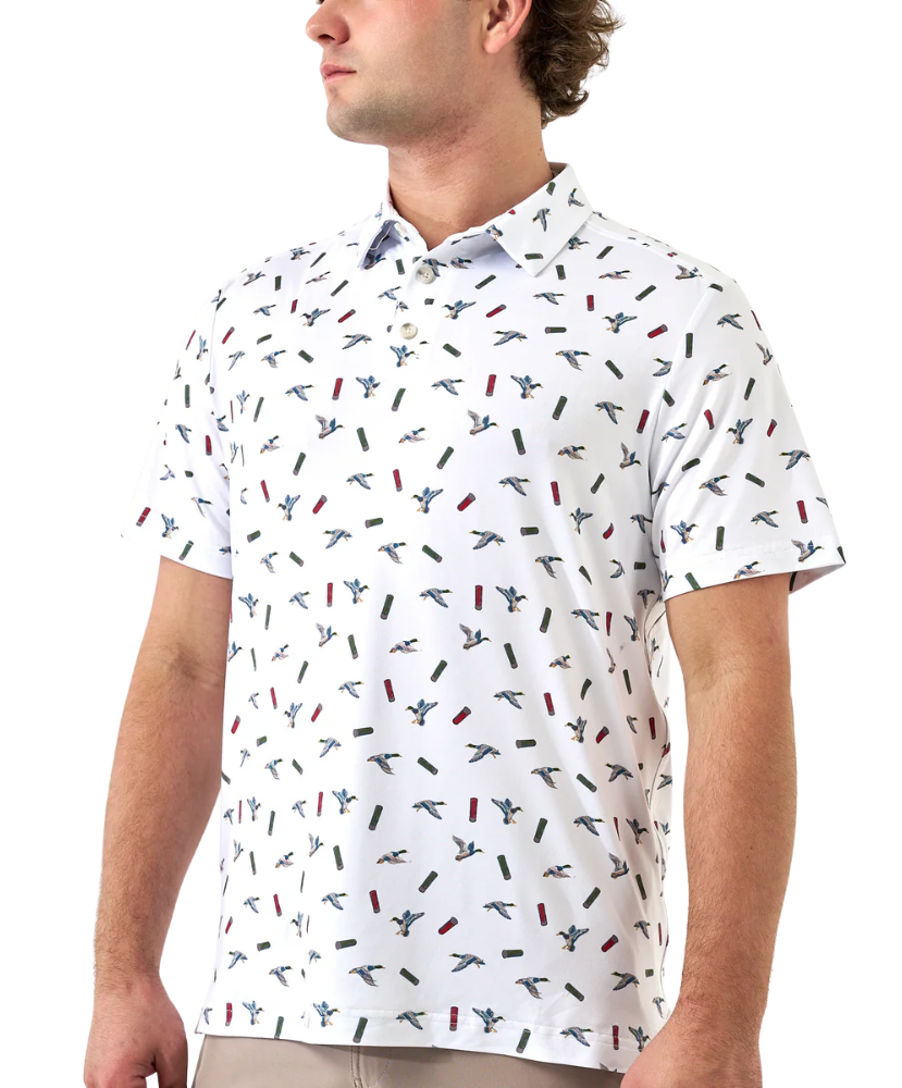 Man wearing a white polo shirt with small colorful ducks and shotgun shells patterns on a white background