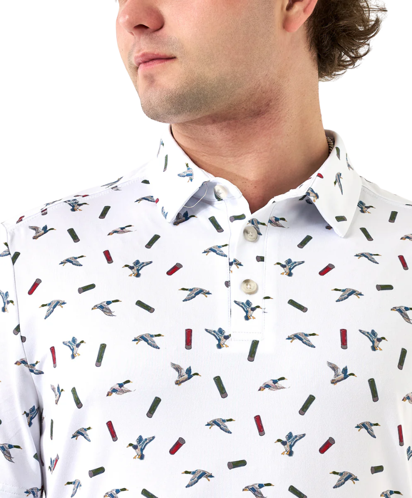 Man wearing a white polo shirt with a duck and shotgun shell pattern of small images and buttons.