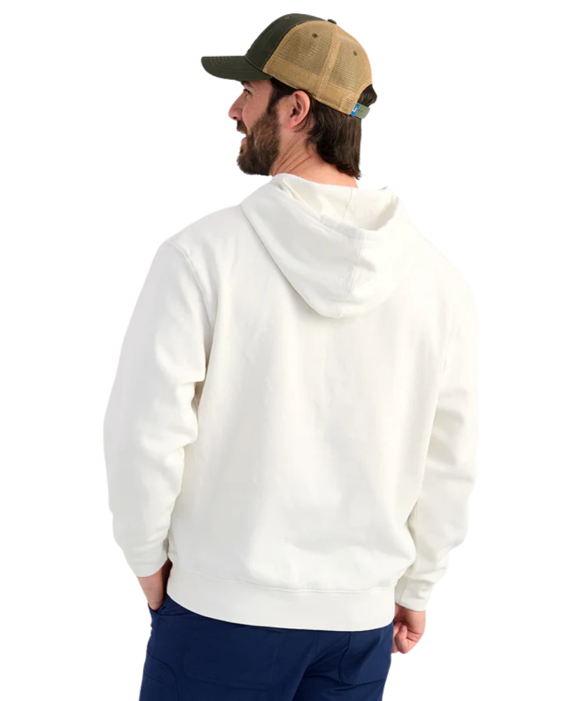 Man wearing a cream hoodie with 'Huk' logo and a cap on a white background