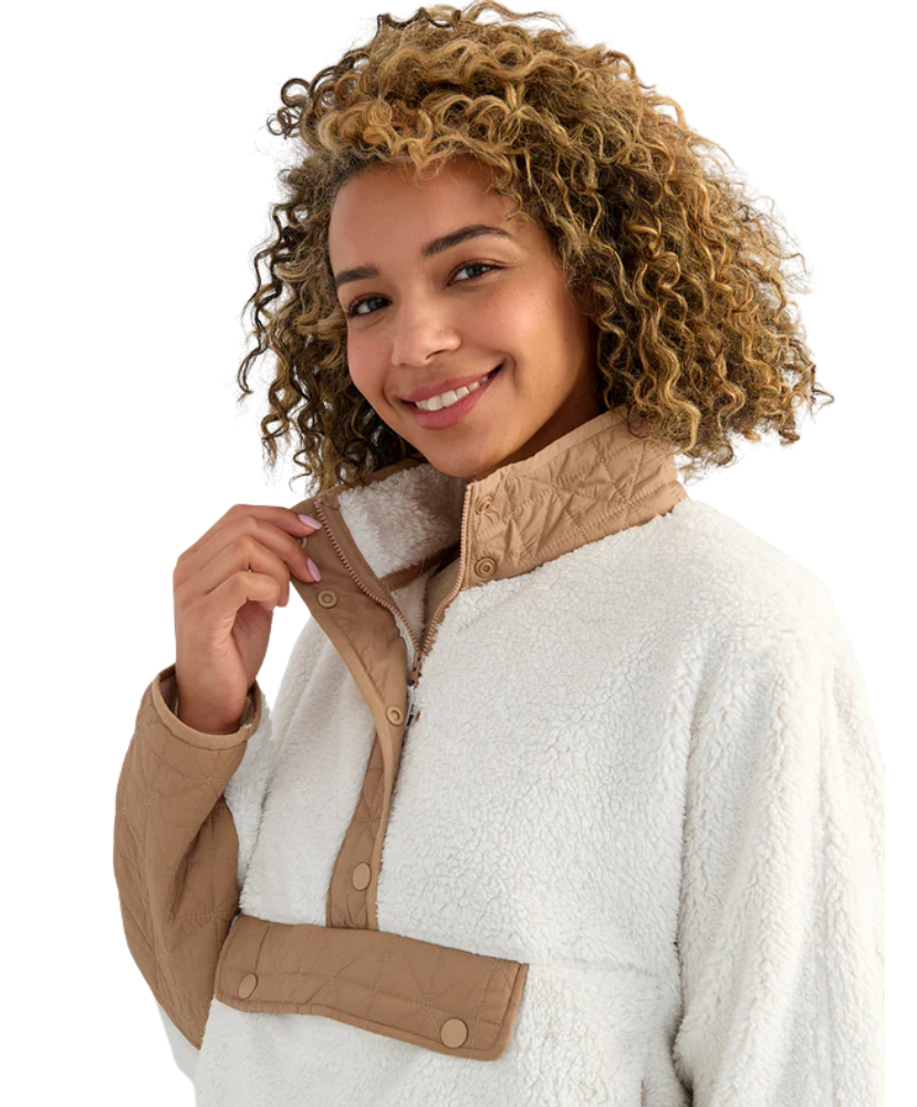 Woman wearing a white and beige fleece pullover on a white background