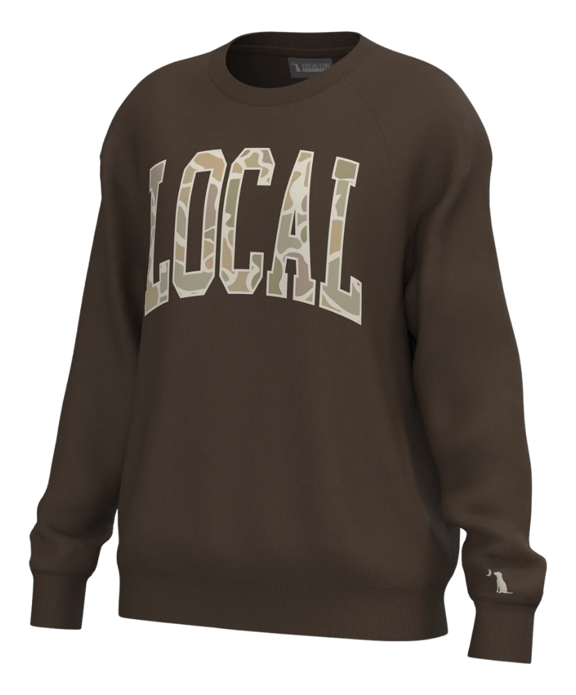 A dark brown crewneck sweatshirt featuring the word 'LOCAL' printed across the chest in large varsity-style letters filled with a camouflage pattern. The sweatshirt is shown on a clean white background.