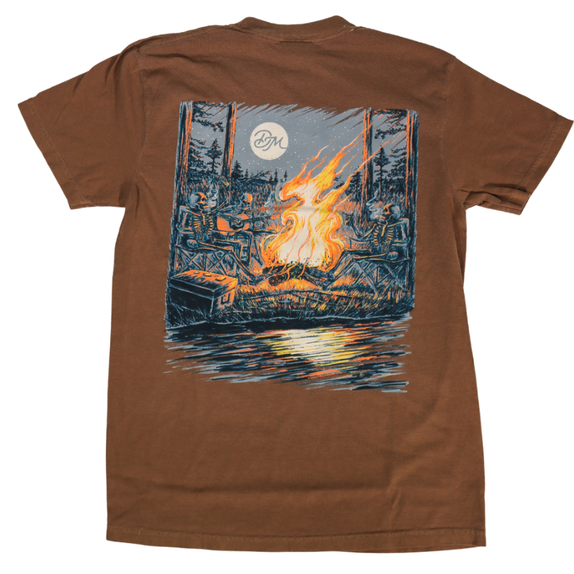 DIRTY MARSH Brown t-shirt with a graphic of a campfire and trees on a white background