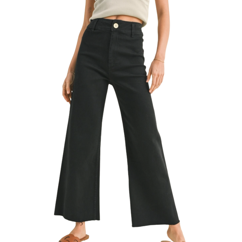 FADE BLACK pants worn by a woman on a white background
