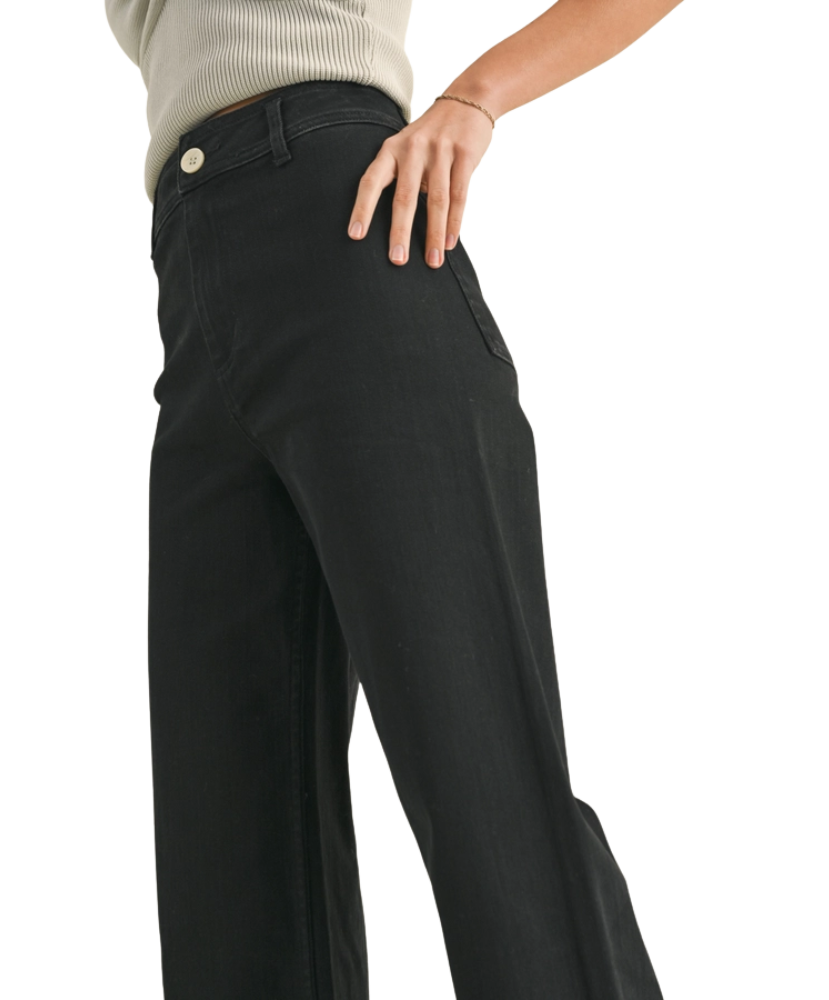 FADE BLACK pants worn by a woman on a white background